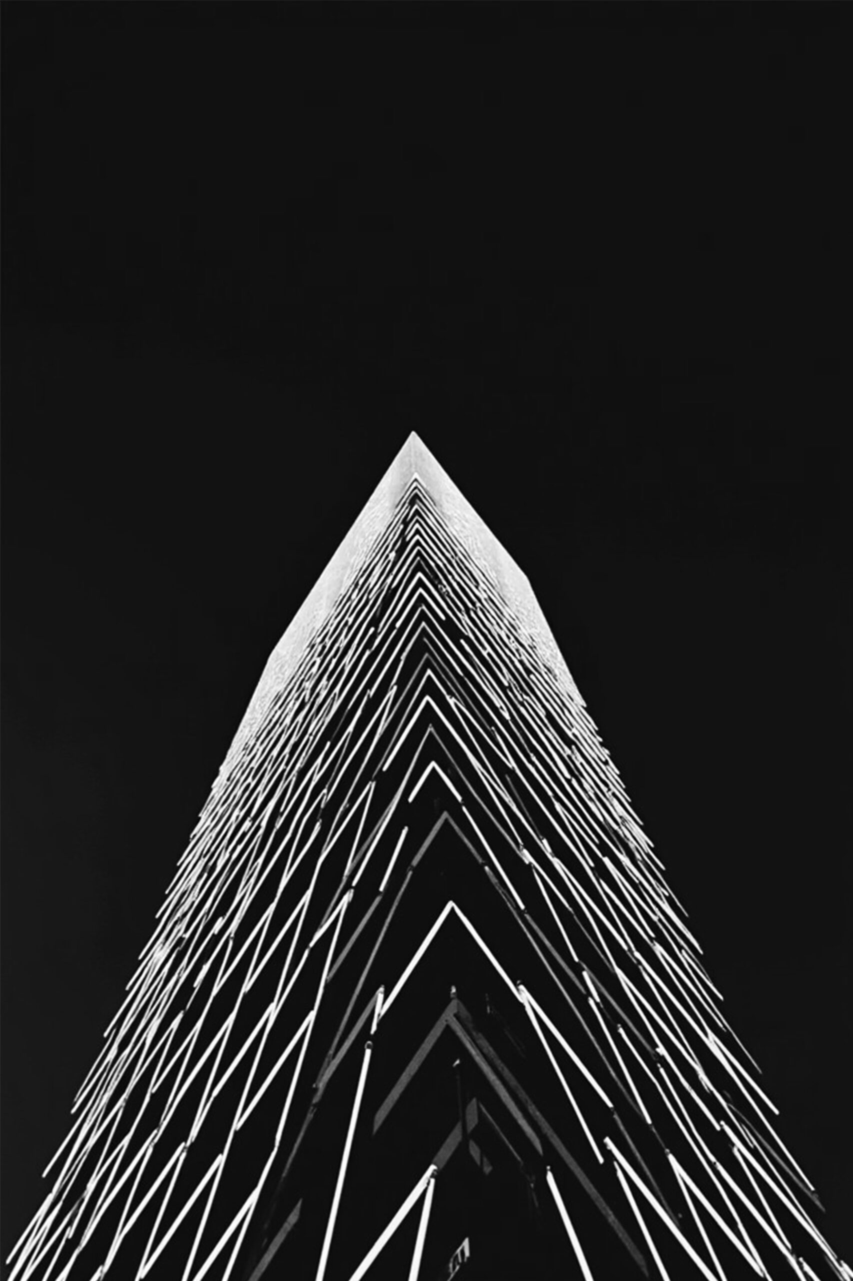 Moroz — Ascension of Light, a black-and-white photograph of a high-rise seen from below, suited to an office reception